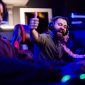 excited gamer with headset giving thumbs up for level up in video game 85x85